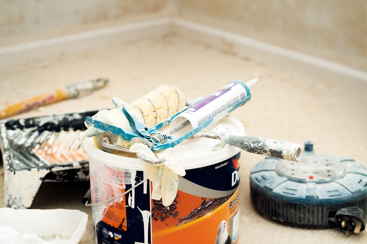 Paint rollers, brushes and a paint bucket ready for a home decorating job